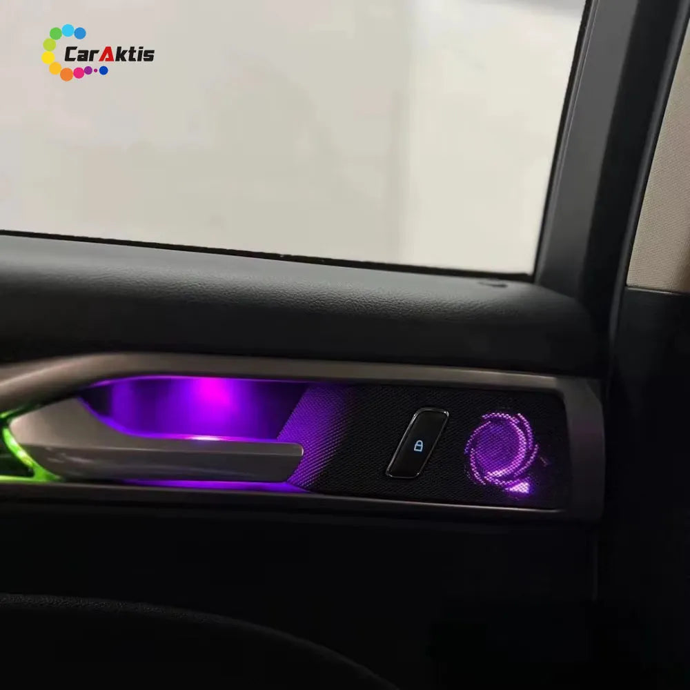 Close-up of purple LED ambient lighting integrated into the door handle and speaker grille of a Ford Mondeo 2013-2021.