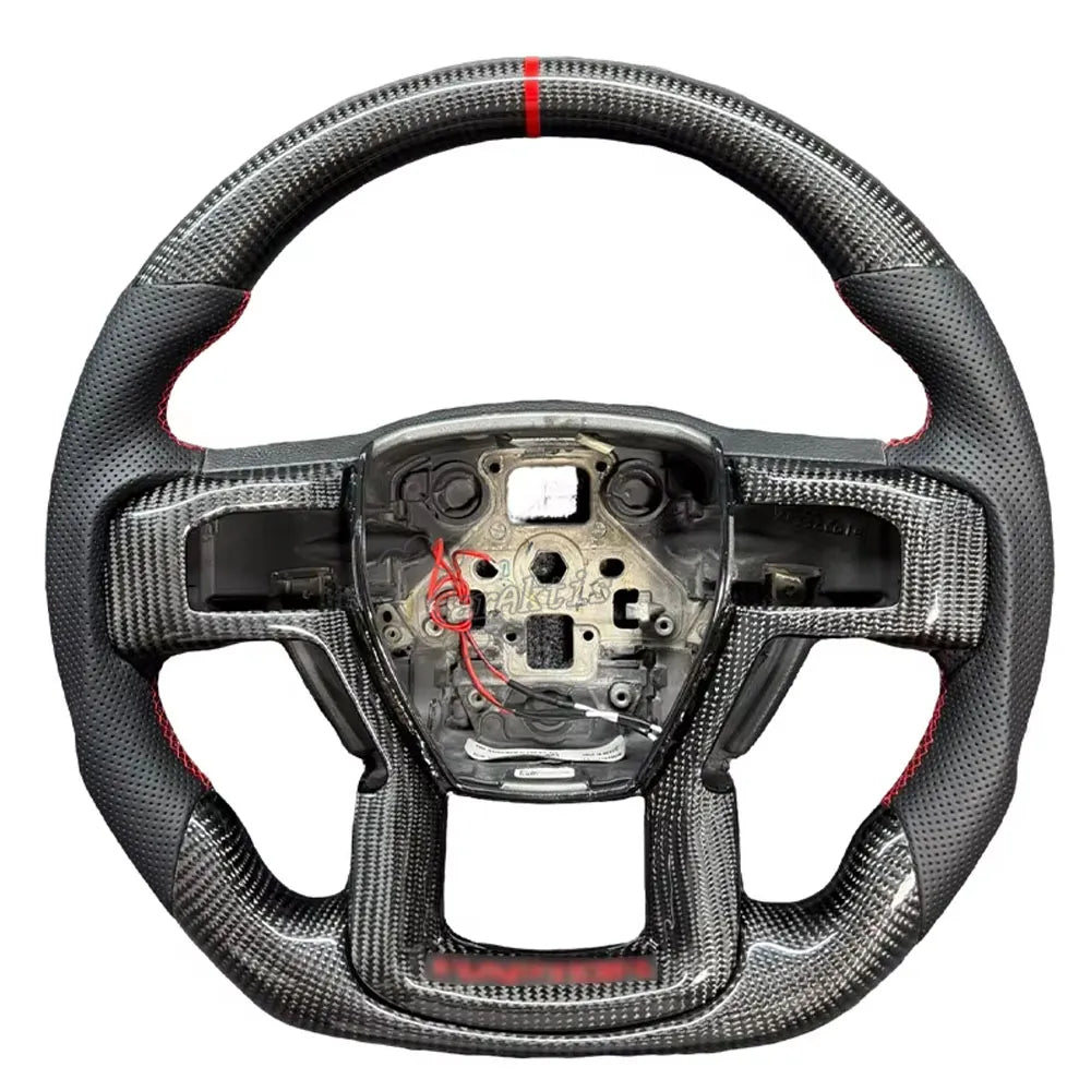 Seamless transition between premium gloss carbon fiber and black leather with vibrant red contrast stitching on a custom Raptor wheel.