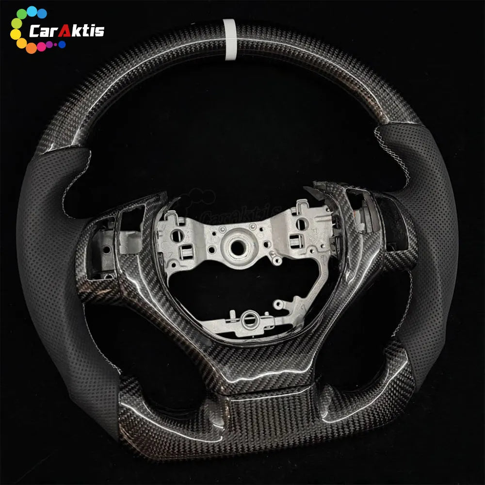 Lexus carbon fiber steering wheel, highlighting the ergonomic side grips and the deep shine of the carbon fiber weave.