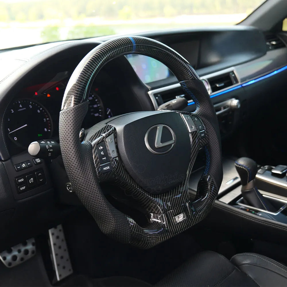 Interior cabin upgrade for Lexus GS featuring a custom carbon fiber steering wheel with integrated paddle shifter.