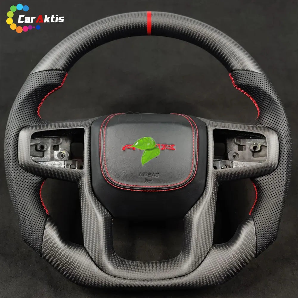 A custom matte carbon fiber steering wheel, paired with black perforated leather grips, creates a non-reflective, race-inspired interior aesthetic.