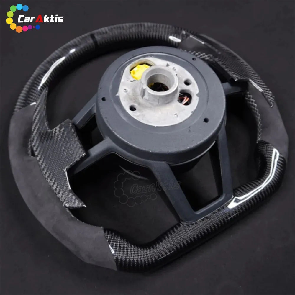 Rear view of a custom McLaren carbon fiber steering wheel showing high-quality construction and OEM-fitment hub.
