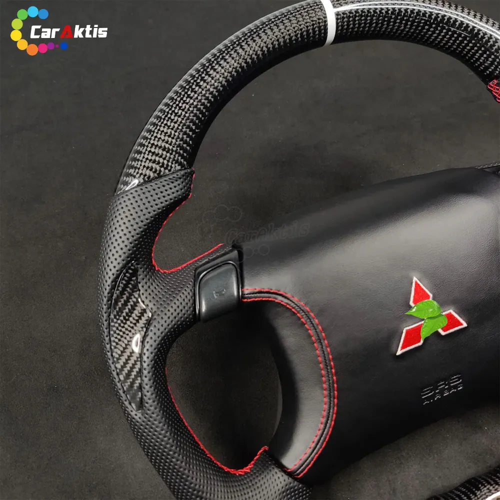 Detailed view of carbon fiber weave and perforated leather grip on a custom Mitsubishi 3000GT steering wheel.