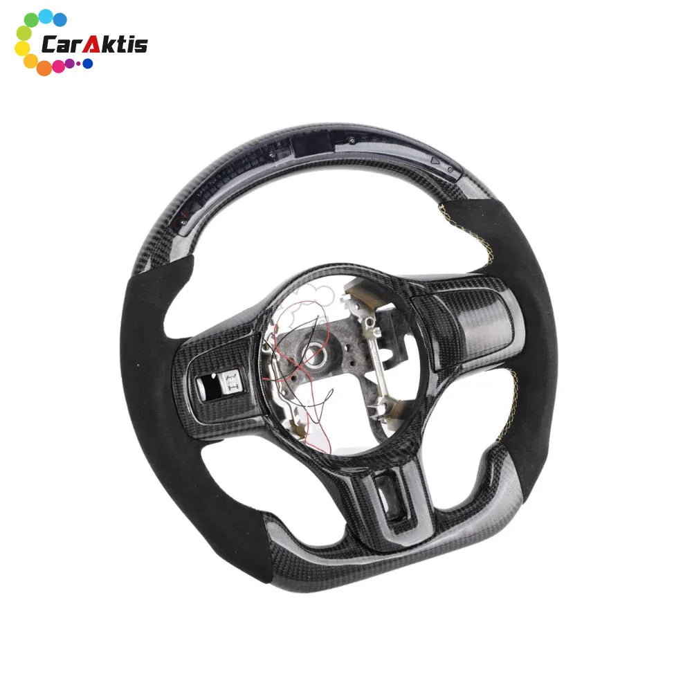 Mitsubishi Lancer Evo X carbon fiber steering wheel with black Alcantara grips and yellow contrast stitching.