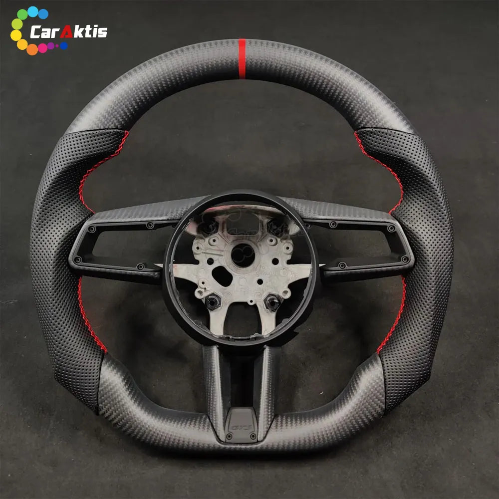 Bare core of a Porsche 992 custom carbon fiber steering wheel showing the internal structure and red center stripe.