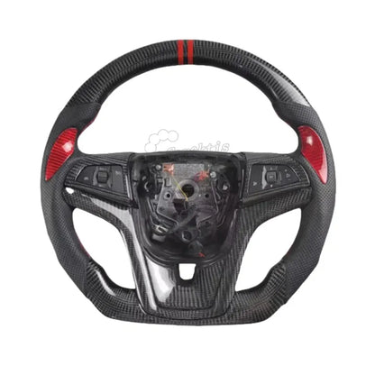 Custom carbon fiber steering wheel for 2012-2024 Chevrolet Camaro featuring double red racing stripes, red carbon fiber side inserts, and black perforated leather with red stitching.