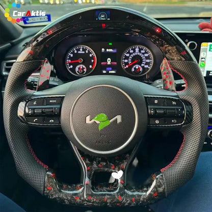 Installed view of 2021-2026 Kia K5 custom carbon fiber steering wheel with LED shift lights and red center line.