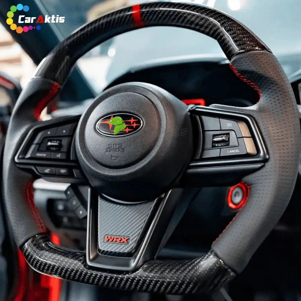 Custom carbon fiber steering wheel for 2022-2026 Subaru WRX installed in car, featuring premium red perforated leather grips and sporty red contrast stitching.
