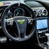 Interior view of a Bentley Continental GT with a custom Alcantara and carbon fiber steering wheel installed in the luxury cabin.
