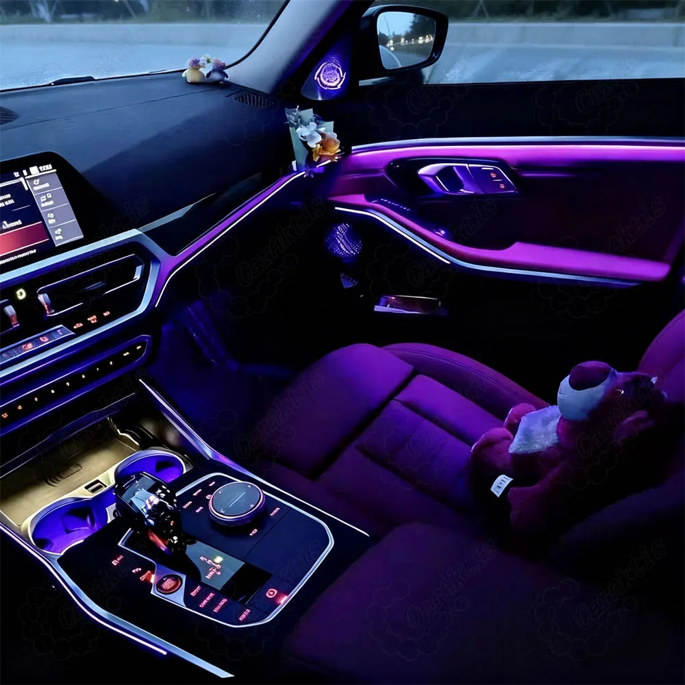 Factory-look center console and door panel ambient light kit installation on a BMW 3 Series sports sedan.