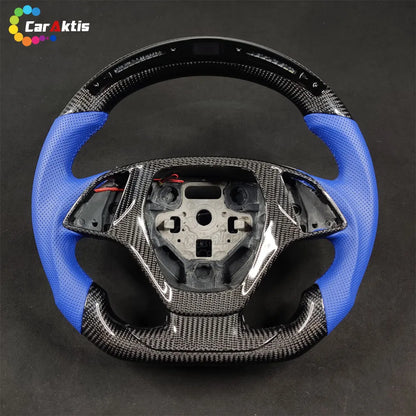 Custom C7 Corvette carbon fiber steering wheel with integrated LED RPM shift light display and black leather grips.