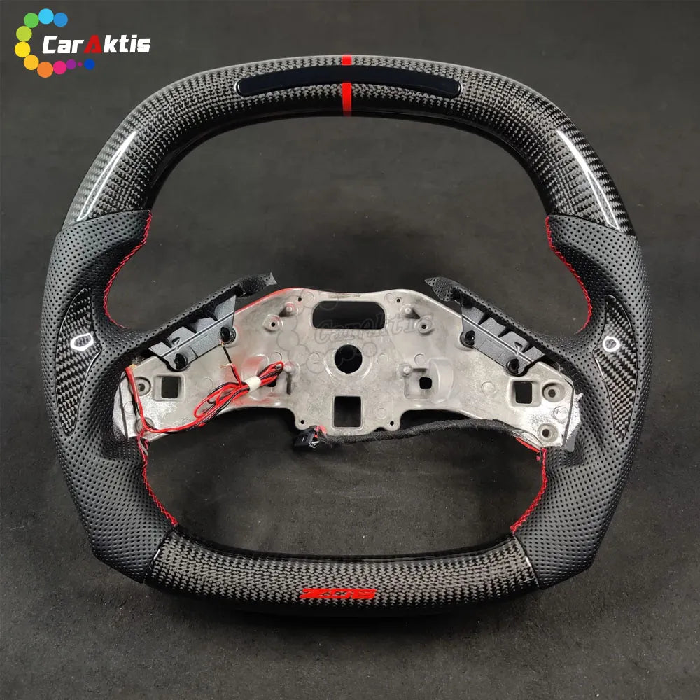 Close-up of premium 3K twill carbon fiber weave on a custom Chevrolet C8 Corvette steering wheel.
