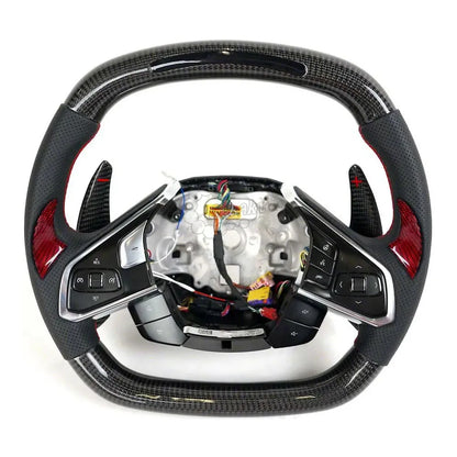 Custom Chevrolet Corvette C8 steering wheel featuring high-gloss carbon fiber, black perforated leather grips with red contrast stitching, and a red center racing stripe.
