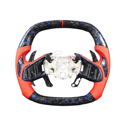 Custom Chevrolet C8 Corvette steering wheel featuring high-gloss carbon fiber top and bottom, black perforated leather side grips, and sporty red contrast stitching with a red 12 o&