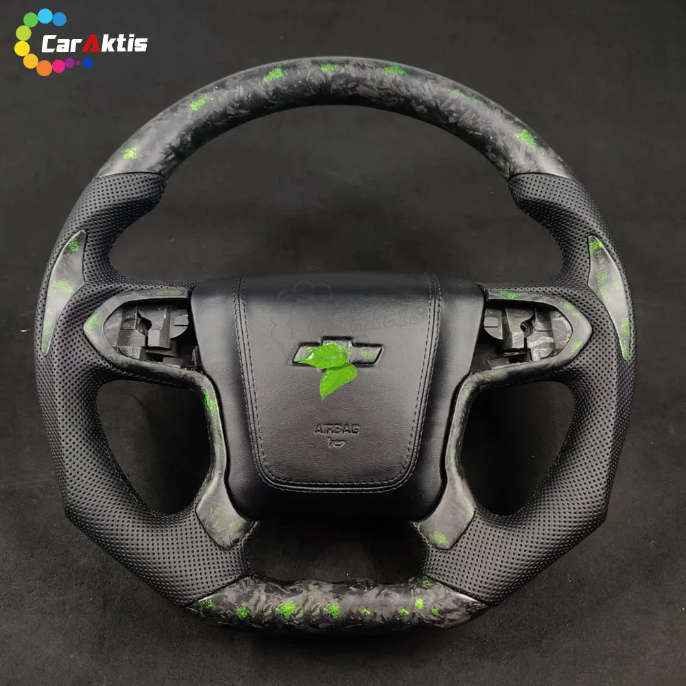 Custom steering wheel for Chevy Silverado featuring exotic green flake forged carbon fiber and black perforated leather grips with green contrast stitching.