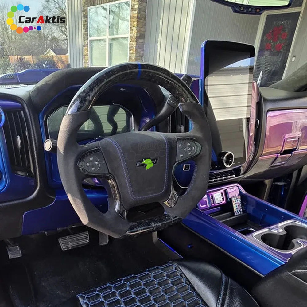 Interior installation of a custom Chevy Silverado steering wheel featuring matte black forged carbon fiber and premium black Alcantara grips for a stealth performance look.