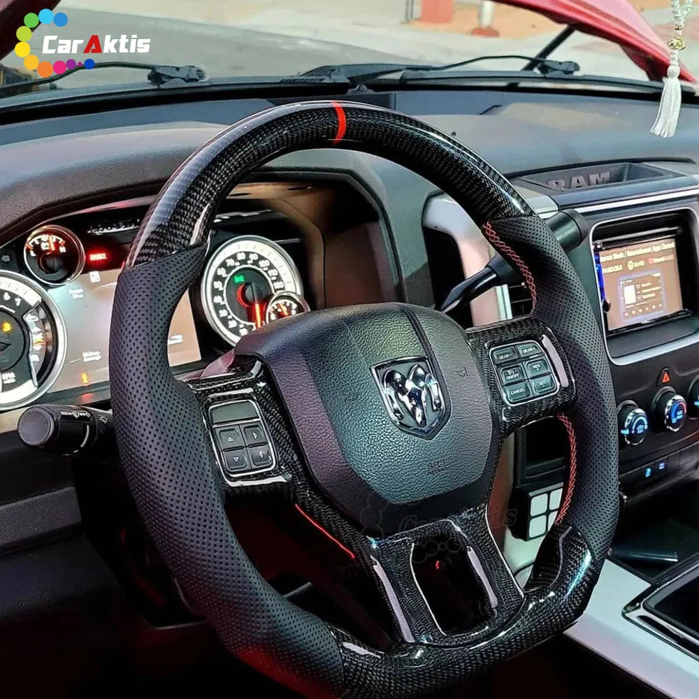 Interior view of a 2012-2018 Dodge Ram with a custom carbon fiber and perforated leather steering wheel installed.