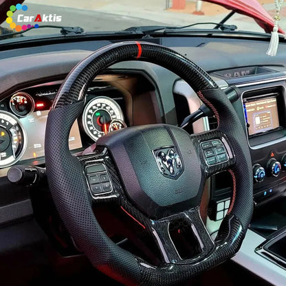 Interior view of a 2012-2018 Dodge Ram with a custom carbon fiber and perforated leather steering wheel installed.
