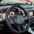 Interior view of a 2012-2018 Dodge Ram with a custom carbon fiber and perforated leather steering wheel installed.