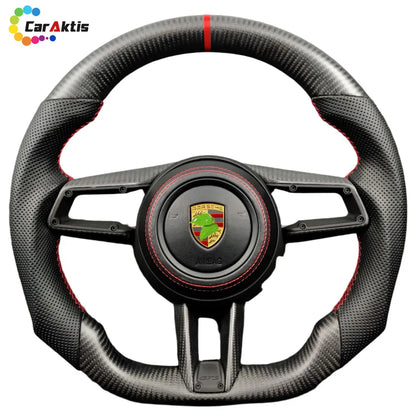 High-performance carbon fiber steering wheel for Porsche 996 Carrera, perforated leather grips with red contrast stitching.