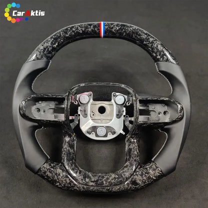 A custom-designed steering wheel featuring a black-and-white forged carbon fiber pattern, with genuine leather grips on both sides that provide exceptional slip resistance and a comfortable hold.
