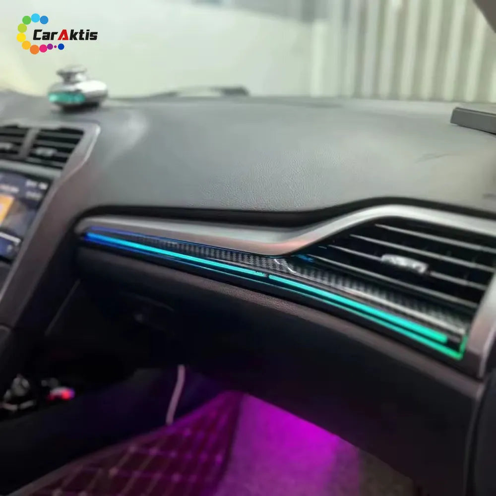 Blue LED dynamic light strip installed on the carbon fiber style dashboard trim of a Ford Mondeo.