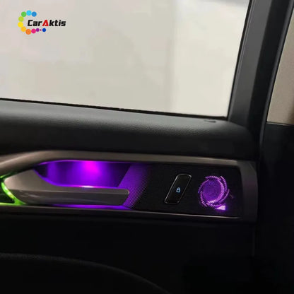 Close-up of purple LED ambient lighting integrated into the door handle and speaker grille of a Ford Mondeo 2013-2021.