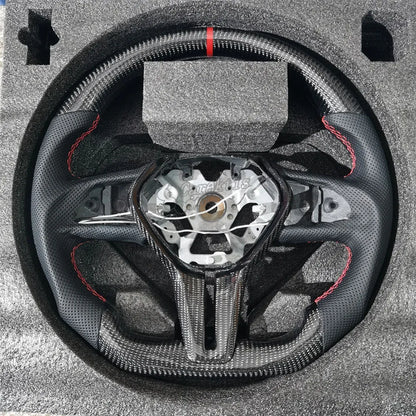 Infiniti Q50/Q60 Carbon Fiber Steering Wheel，The top and bottom sections feature a unique high-gloss carbon fiber finish, showcasing a distinctive texture. Both sides are wrapped in perforated genuine leather, accented by tri-color red stitching and a red top-center marker.