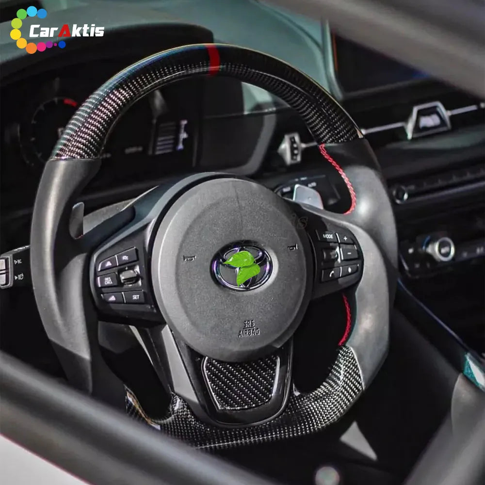 Professional installation of a custom carbon fiber steering wheel in a Toyota Corolla interior.
