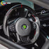 Professional installation of a custom carbon fiber steering wheel in a Toyota Corolla interior.
