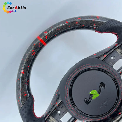 Close-up of glossy carbon fiber and black leather steering wheel with red stitching for Kia K5 Optima.