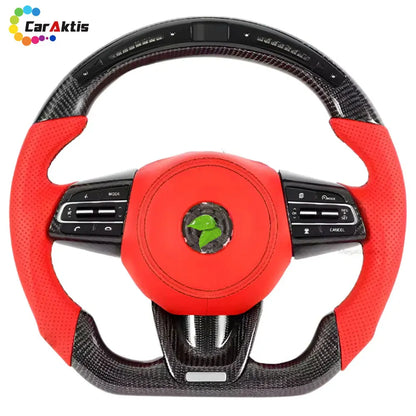 2021-2026 Kia K5 LED display steering wheel with premium red perforated leather grips and carbon fiber.