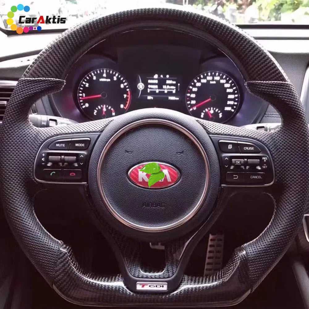 Dashboard view of an installed custom carbon fiber LED steering wheel in a Kia Optima interior.