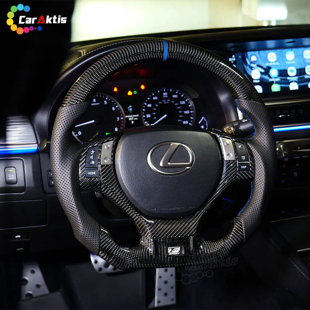 Close-up of the button bezel area on a Lexus GS carbon fiber steering wheel, ensuring 100% fitment for original factory airbag.