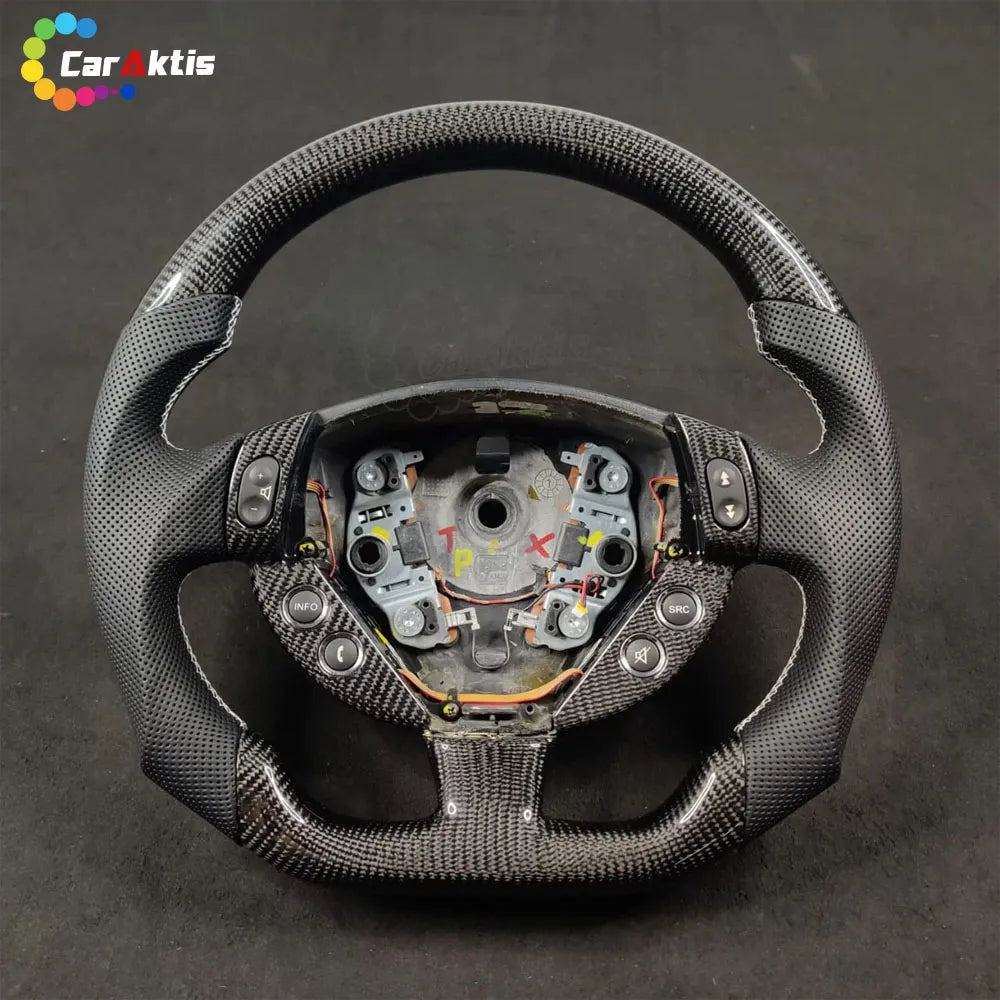 Maserati GranTurismo custom steering wheel featuring perforated leather grips and carbon fiber trim.