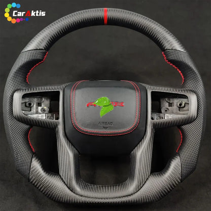 A custom matte carbon fiber steering wheel, paired with black perforated leather grips, creates a non-reflective, race-inspired interior aesthetic.