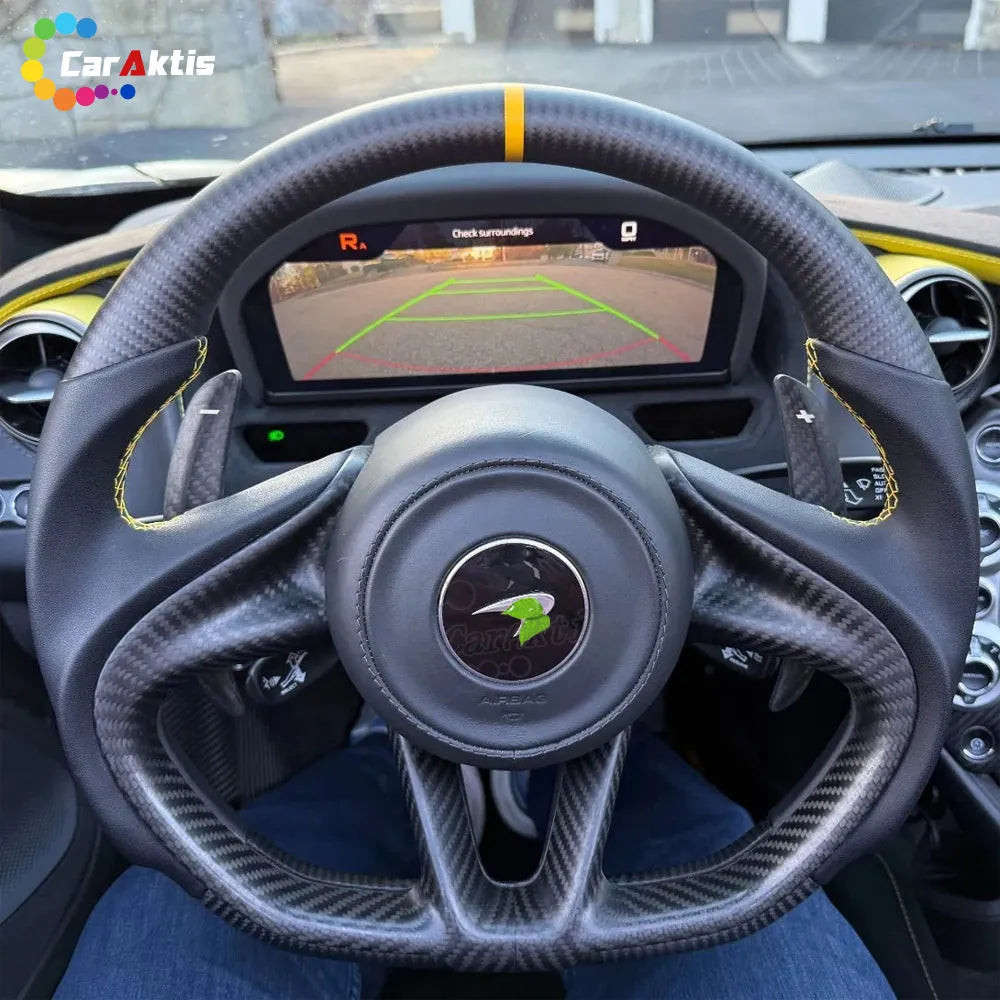 Bespoke McLaren 720S carbon fiber steering wheel featuring yellow contrast stitching and a yellow center marker.