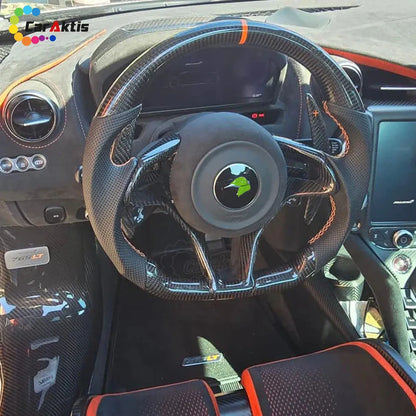 Custom carbon fiber steering wheel installed in a McLaren 765LT, featuring orange 12 o&