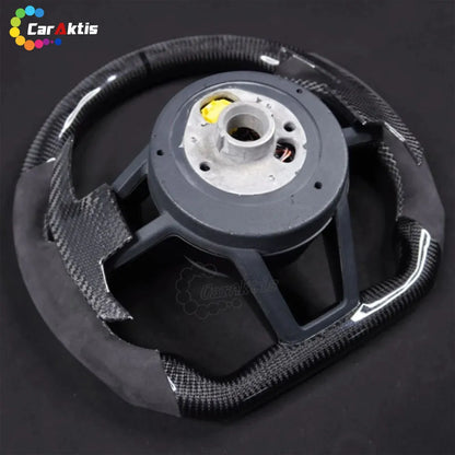 Rear view of a custom McLaren carbon fiber steering wheel showing high-quality construction and OEM-fitment hub.