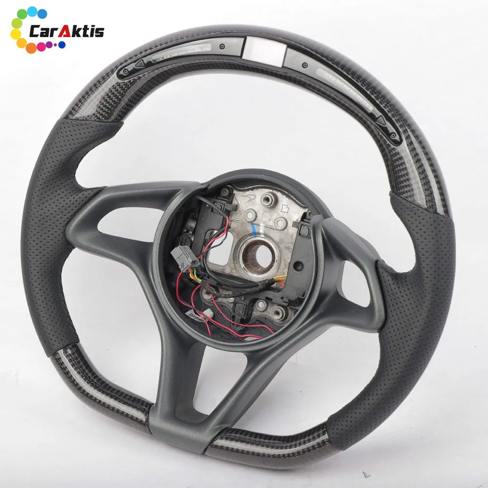 McLaren custom carbon steering wheel with integrated LED shift lights display and black perforated leather side grips.