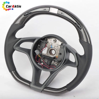 McLaren custom carbon steering wheel with integrated LED shift lights display and black perforated leather side grips.