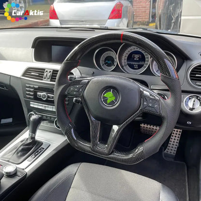 Installed custom carbon fiber steering wheel on Mercedes-Benz C-Class W204 with red center stripe.