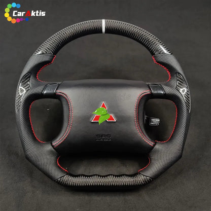 Mitsubishi 3000GT GTO custom steering wheel featuring carbon fiber, perforated leather, red stitching, and 3000GT logo.