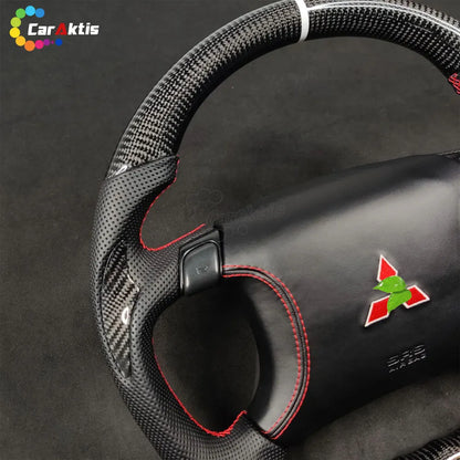 Detailed view of carbon fiber weave and perforated leather grip on a custom Mitsubishi 3000GT steering wheel.