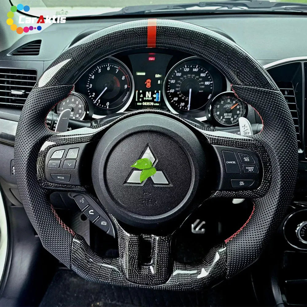 Installed custom carbon fiber steering wheel on Mitsubishi Lancer Evo X dashboard showing paddle shifters and gauges.