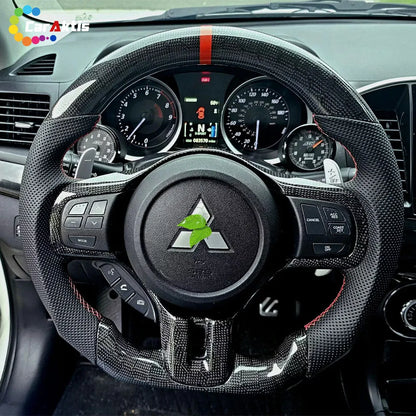 Installed custom carbon fiber steering wheel on Mitsubishi Lancer Evo X dashboard showing paddle shifters and gauges.