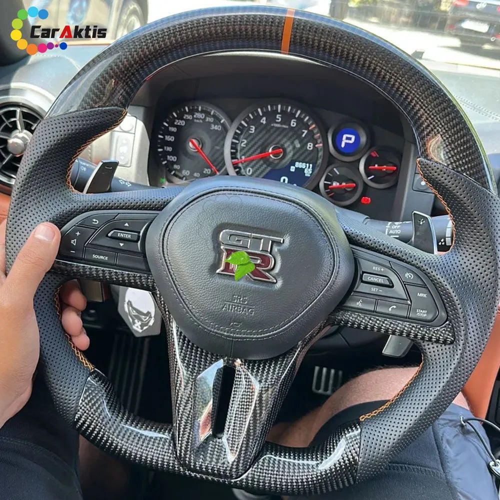 Close-up of GTR R35 custom steering wheel with orange 12 o&