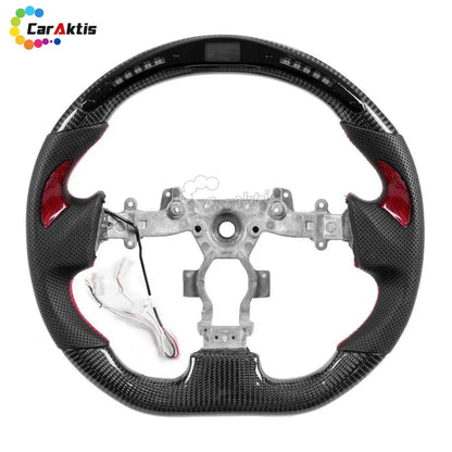 Nissan GT-R R35 carbon fiber steering wheel with integrated LED RPM shift light display and black perforated leather grips.