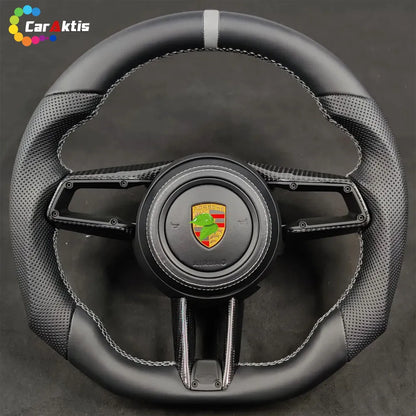 Custom Porsche carbon fiber steering wheel with black perforated leather, grey center stripe, and GTS trim logo.