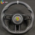 Custom Porsche carbon fiber steering wheel with black perforated leather, grey center stripe, and GTS trim logo.